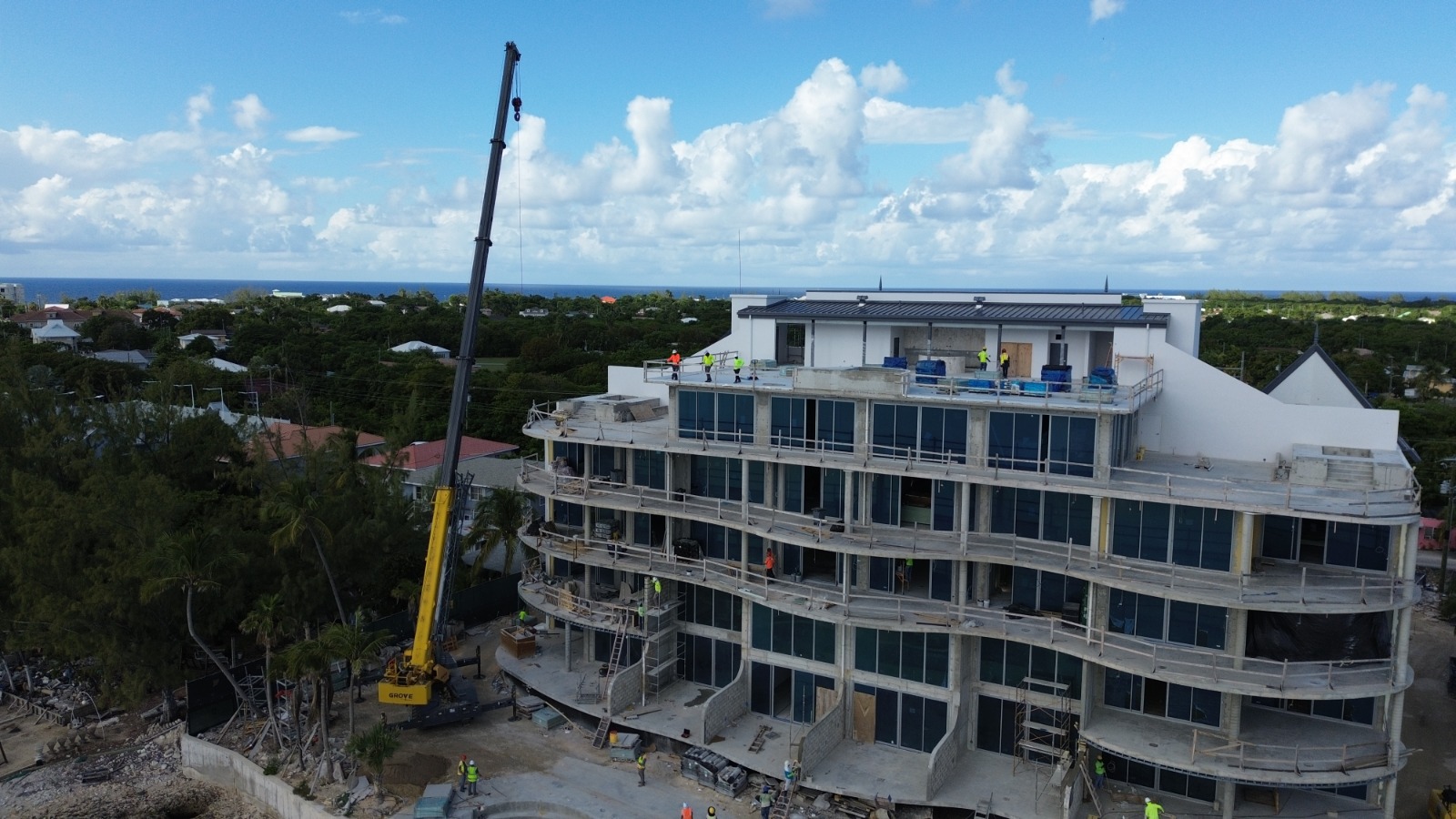 Crane working beside a multi-storey building in Cayman